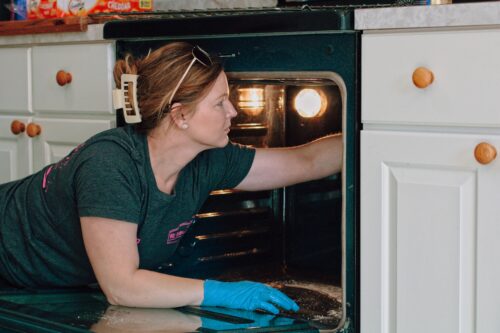 Woman cleaning a stove